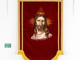 a close up of a red banner with a picture of jesus on it