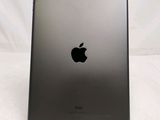 the back of an ipad with a black apple logo on it