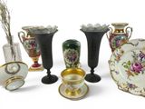 many vases and plates that are sitting on a table