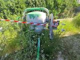 a green machine that is sitting in the middle of a field