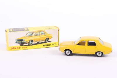 yellow toy car sitting next to a boxed box on a white surface