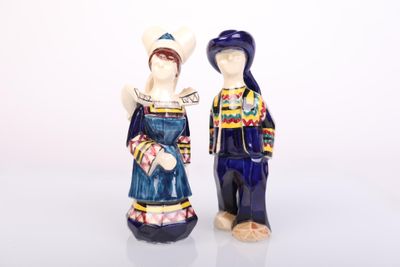 two figurines of a man and a woman standing next to each other