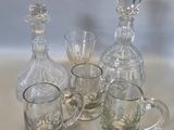a number of glass items on a table next to each other