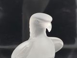 a glass bird that is sitting on top of a table
