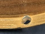 a close up of a piece of wood with a hole in it