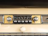 a close up of a car dashboard with a clock and radio