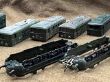 a lot of toy trains that are sitting on the ground