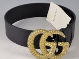 une ceinture en cuir noir avec une boucle dorée et une ceinture noire avec une boucle dorée