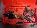 a red tool box with a drill and a cord
