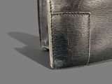 leather wallet on grey background with shadow on the ground