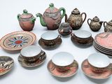 many different types of teapots and saucers on the table