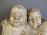 a statue of two babies that are sitting together