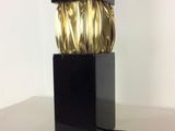 a lamp that is on a table with a black base