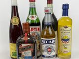 several bottles of alcohol are lined up on a white surface