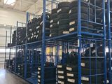 a lot of tires stacked on a rack in a warehouse