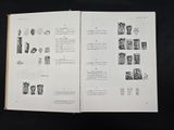 an open book with drawings on it on a black surface