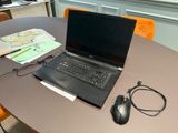 a laptop computer sitting on a table with a mouse