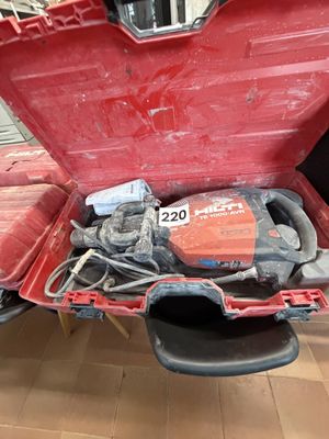 a red box with tools inside of it on the floor