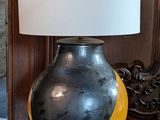 a lamp that is sitting on a table in front of a mirror