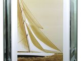 framed photograph of a sailboat in a glass frame on a white background