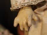 a close up of a doll with a hat on