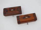 pair of wooden boxes with metal handles on a white surface