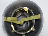 a close up of a helmet with a green belt