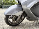 a close up of a motorcycle parked on a gravel road