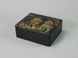 a small black box with a floral design on it