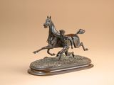 statue en bronze représentant un cheval et son cavalier, posée sur un socle en bois