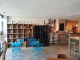 a room with a lot of tables and chairs in it