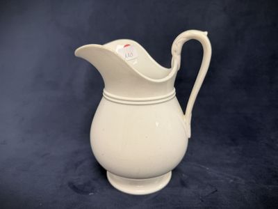 a white pitcher that is sitting on a table