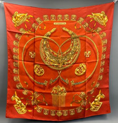 a red and gold silk scarf with a bird on it