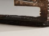 a close up of a metal object on a white surface