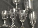 five wine glasses sitting on top of a black table