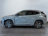 a silver suv parked in a room with a white wall