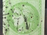 un timbre vert sur lequel figure le visage d'une femme
