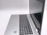 a silver laptop with a blue sticker on it