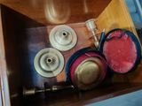 a wooden box filled with hats and other items