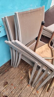a chair that is sitting on a deck by a pool