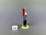 figurine of a man holding a baseball bat on a green base