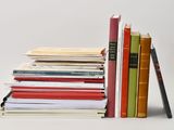 a stack of books sitting next to each other on a table