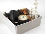 a white box with a clock and other items in it