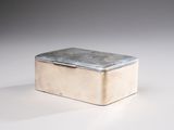 a small silver box sitting on a white surface
