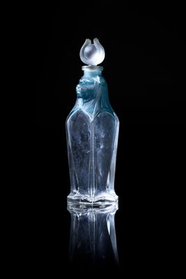 a clear glass bottle with a bird on top of it
