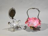 two glass vases with flowers on them on a white surface