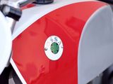a red and white motorcycle parked on the side of the road