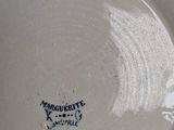 a white plate with a blue writing on it