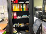 a chair that is sitting in front of a book shelf