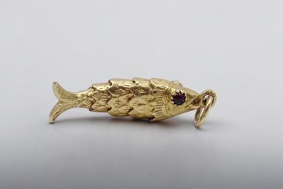 une image représentant une broche en forme de poisson rouge sur fond blanc
